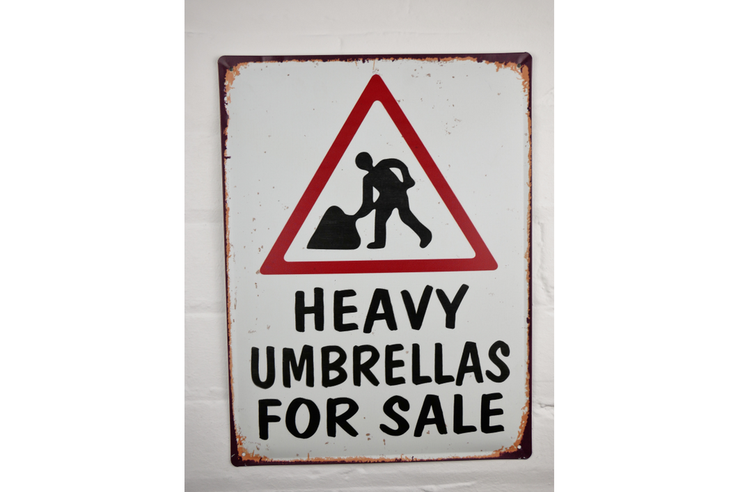 Comical street sign - Huge umbrellas for sale
