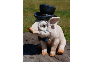 Garden pig ornament wearing monocle and top hat
