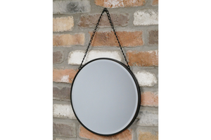 Circular black mirror with hanging chain